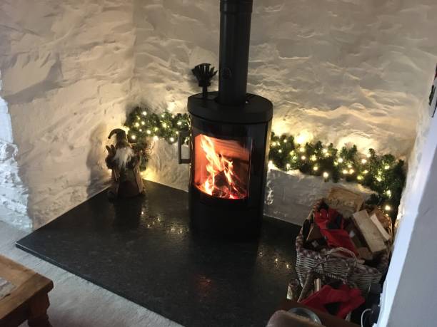 A modern log burner in a white painted fireplace
